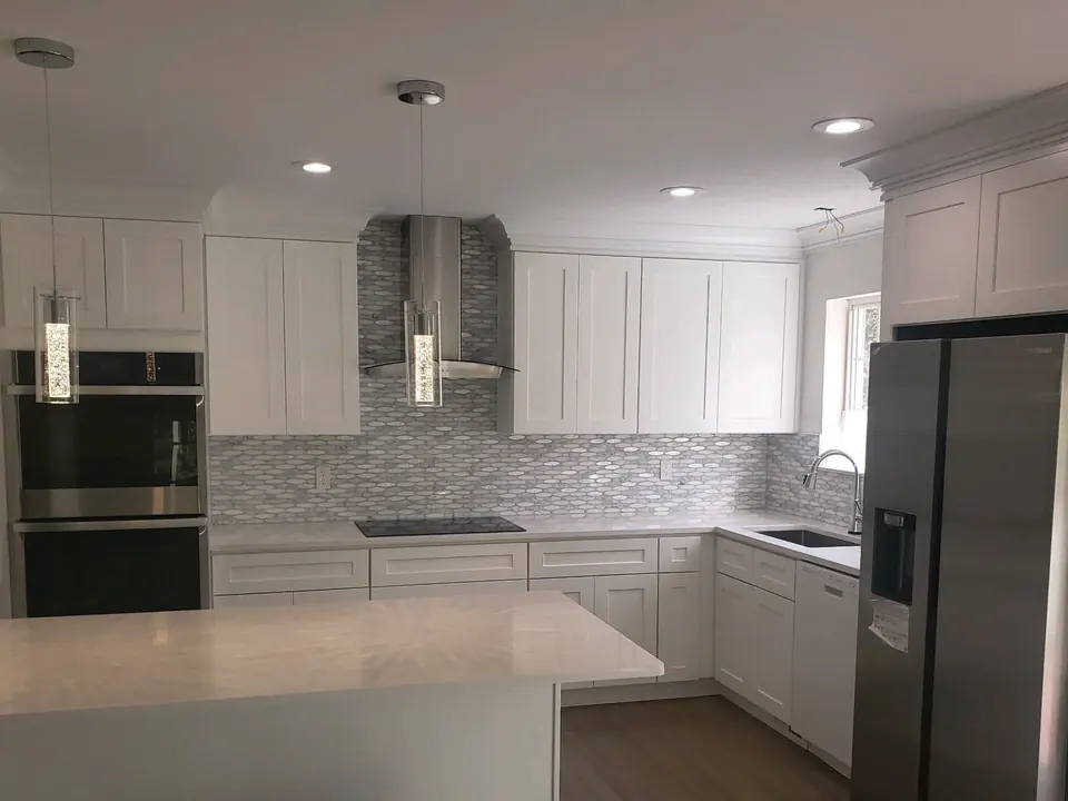 Stamford kitchen after remodel: white shaker cabinets and quartz island