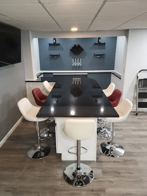 Basement bar with white stools