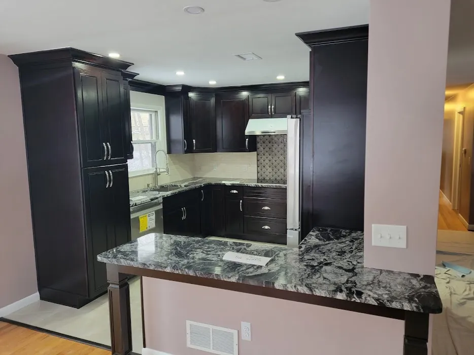 Dark espresso cabinets with exotic granite peninsula