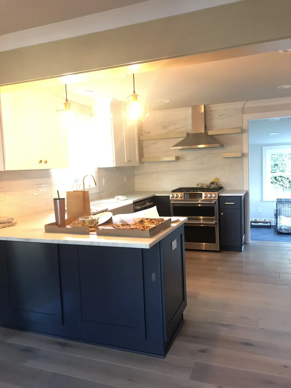 Navy kitchen island with light oak floors