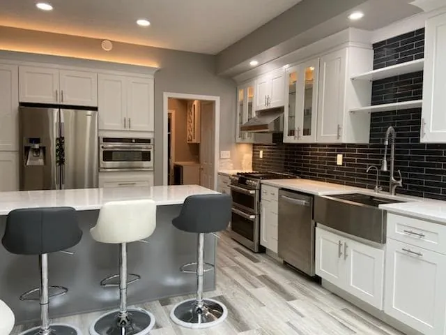 White kitchen with navy subway backsplash and gray island